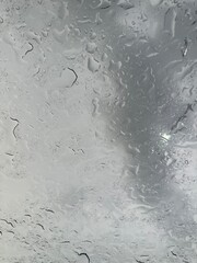 Rain falling through the glass, The sight of rain from the sky, Rain falling through clear glass.