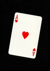 A playing card in the suit of hearts isolated on a black background.
