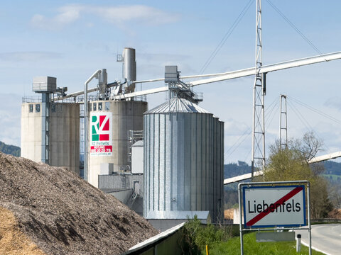 Industrial grain silos near rural road and liebenfels sign in countryside