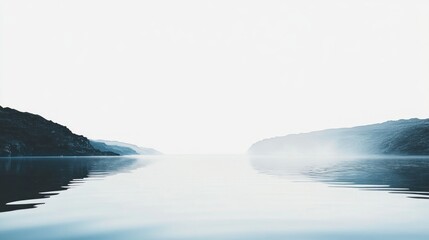 Serene lake with misty mountains reflected