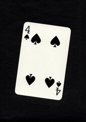 Playing card in the suit of spades isolated on a black background.