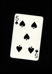 Playing card in the suit of spades isolated on a black background.