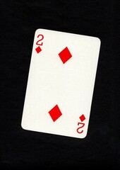 Playing card in the suit of diamonds isolated on a black background.