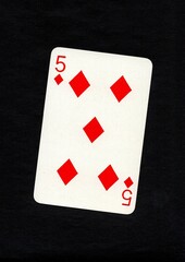 Playing card in the suit of diamonds isolated on a black background.