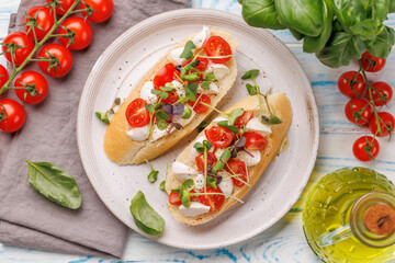 Tasty antipasto toasts featuring classic caprese with mozzarella and tomatoes, and savory prosciutto with herbs