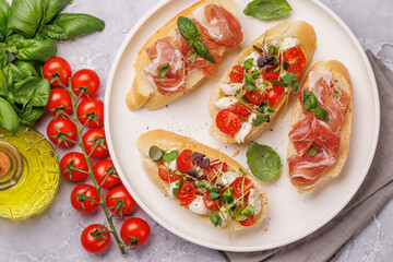 Tasty antipasto toasts featuring classic caprese with mozzarella and tomatoes, and savory prosciutto with herbs