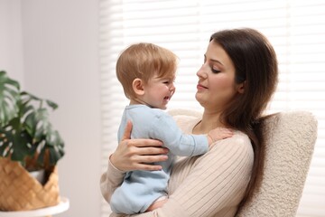 Mother with her cute little baby at home