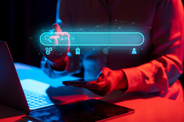 Businessperson with a mobile phone touching a search engine bar icon. Technology innovation on a...