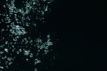 Obraz premium Many water bubbles on black background, closeup. Space for text