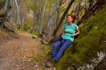 Hiker resting on mossy tree
