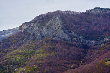 Craggy spring mountain ridge with forest and rocky slope