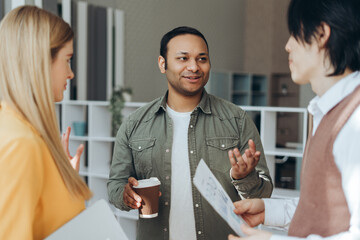 Diverse business team discussing marketing data in modern office