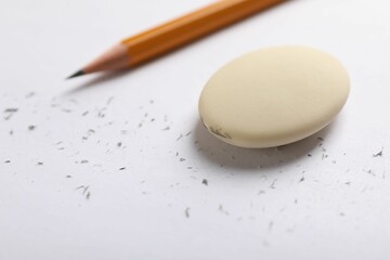 Eraser, pencil and scraps on paper, closeup