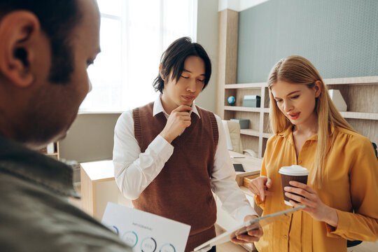 Business team analyzing financial data and reports in modern office