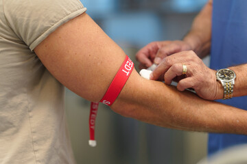 Close up of drawing blood from patient's arm.