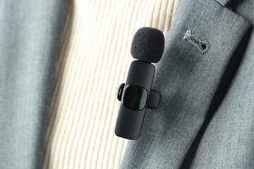 Woman with lavalier microphone on her shirt, closeup
