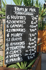 blackboard with oyster tasting and aperitif prices written