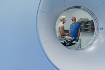 Doctor explaining CT scan results to patient in hospital setting