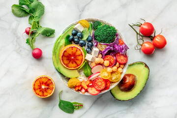 Buddha Bowl. Rainbow salad. Vegan poke bowl with avocado. Healthy food. Overhead flat lay shot with ingredients