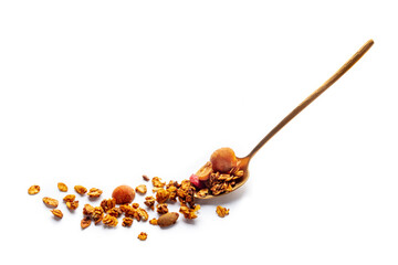 Granola in a spoon on a white background. Organic gourmet muesli. Oat flakes, goji berries, and nuts, with copy space