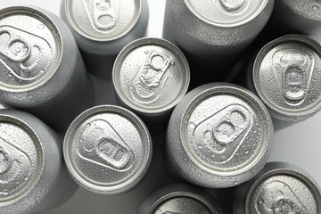 Many different tin cans on light background, top view