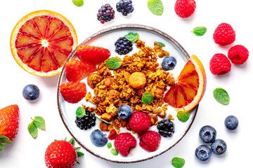 Granola with yogurt and fresh fruit. Organic gourmet muesli with ingredients, overhead flat lay shot on a white background