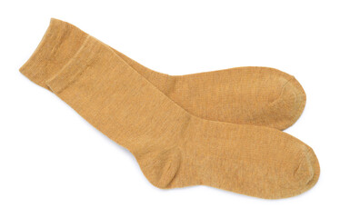 Pair of dark yellow socks isolated on white, top view