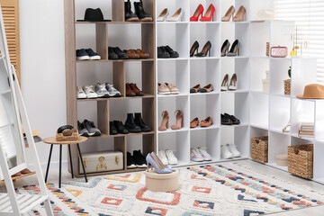 Shoe storage. Shelving units with different footwear and accessories indoors