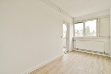 A clean, minimalist interior with ample natural light from large windows, featuring white walls and light wooden flooring, ideal for various design inspirations.