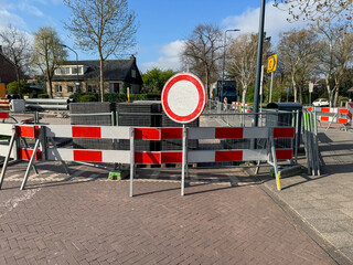 Road sign and barricade on city street