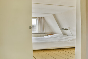 A serene and inviting bedroom highlighting minimalist design, soft textures, and ample sunlight streaming through the curtains.