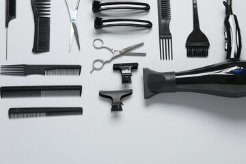 Different hairstyling tools on white background, flat lay. Space for text