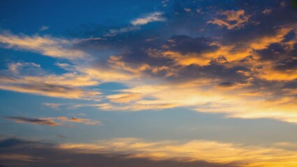 Obraz premium Glowing sunrise or sunset through clouds. Sky with vibrant hues and soft gradation from blue to orange. Calm, serene end of day.