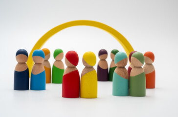 The wooden men appear to be talking in front of a yellow bridge.