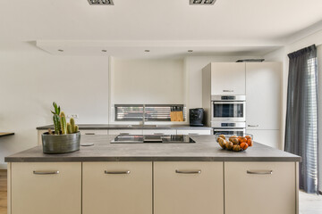 A sleek and stylish modern kitchen with minimalist cabinetry, an island countertop, and a focus on...