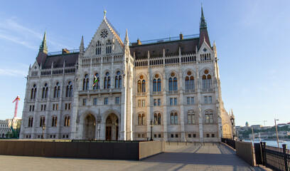 Detailed exterior views of the Hungarian Parliament Building in Budapest showcasing neo-Gothic architecture, pointed spires, arches, and ornate stonework