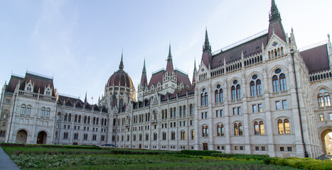 Detailed exterior views of the Hungarian Parliament Building in Budapest showcasing neo-Gothic architecture, pointed spires, arches, and ornate stonework