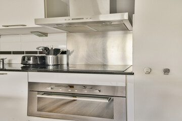 A contemporary kitchen featuring sleek appliances, minimalist design, and a clean aesthetic. The...