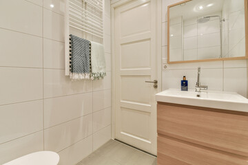A stylish modern bathroom featuring elegant fixtures and a clean design. The light colors and minimalist decor create a serene atmosphere.