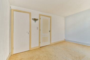 A minimalist empty room featuring light-colored walls, two doors, and a simple wall light, showcasing a clean and modern aesthetic.