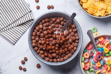 Breakfast chocolate balls in bowl on white background, top view.