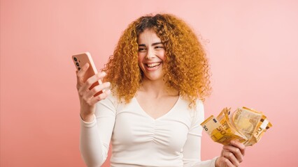 Cheerful ethnic woman with smartphone and cash