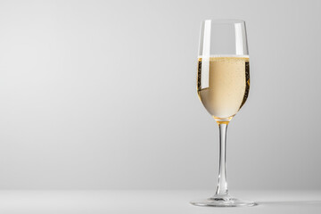 Elegant champagne flute filled with spa quality bubbles relaxing lounge beverage photography minimalist gray background up-close view sophisticated celebration concept