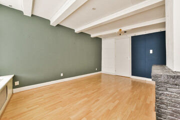 A spacious, modern interior featuring minimalistic design elements, wooden flooring, and a blend of light and dark wall colors, ideal for contemporary living.