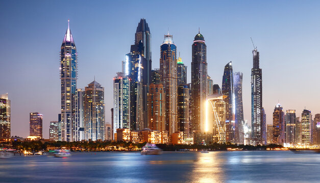 Dubai skyline Marina with reflecion at colorful sunset, UEA