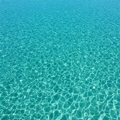 Crystal clear turquoise water with sun reflections creating abstract patterns on the surface. Calm and serene aquatic scene. High resolution