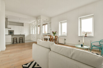 A stylish, bright living room with natural light. featuring minimalist furniture and a modern...