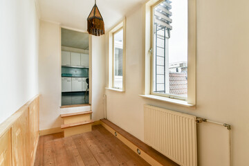 A well-lit minimalist interior featuring wooden flooring and large windows, creating an inviting atmosphere. Ideal for showcasing modern decor ideas.