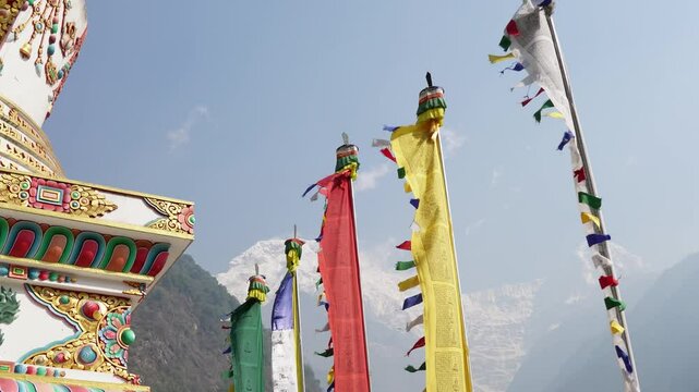 Chhomrong Gumba Stupa decorated with colorful prayer flags in Annapurna Base Camp trek, Nepal.