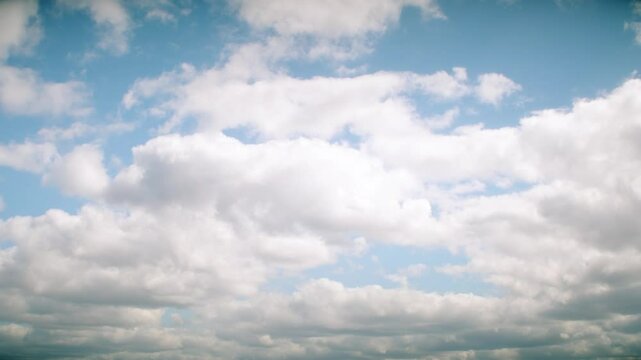 Dramatic sky almost completely covered with cumulus clouds. Slowly moving huge clouds. Atmosphere before a storm or rain.